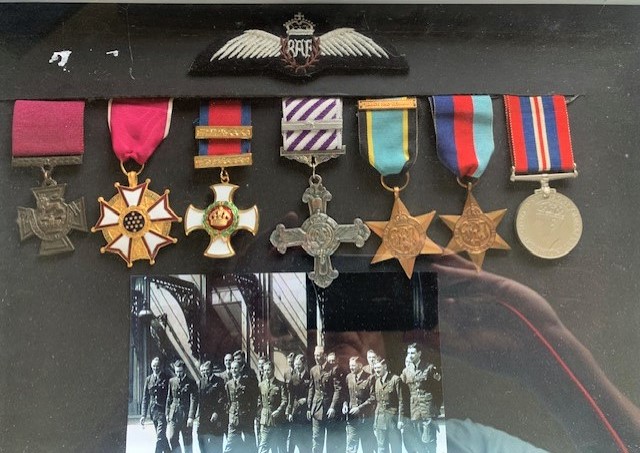 Set of copy medals awarded to Wing Commander Guy Gibson with a picture of his fellow officers at Scampton